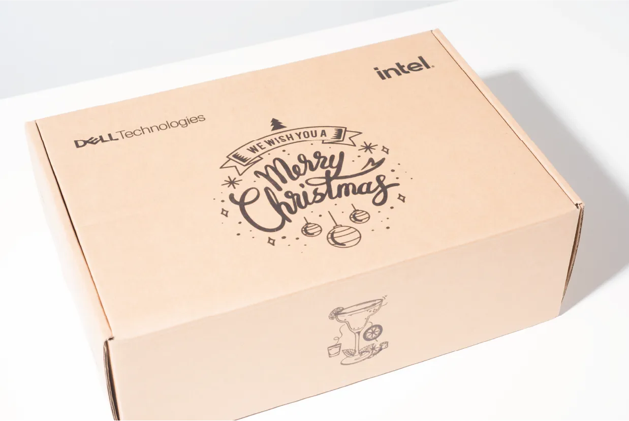 Kraft mailer showing the Merry Christmas lettering on the lid and a line drawing on the front panel