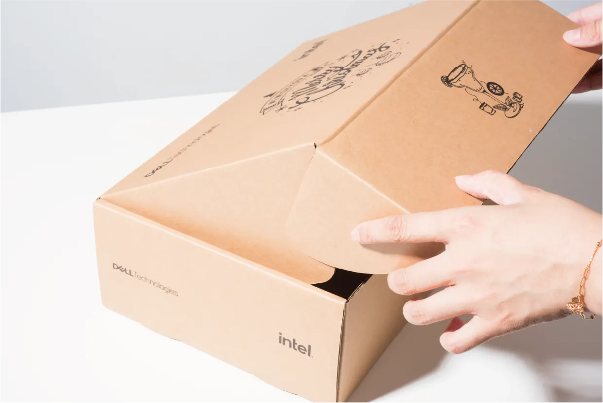 A hand lifting the lid of the kraft mailer