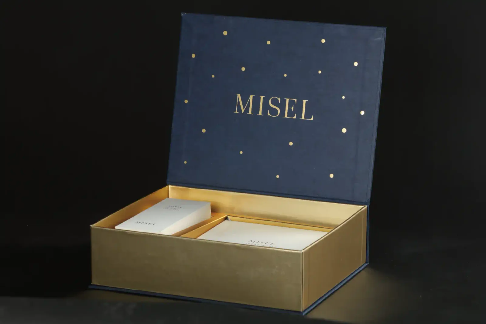 打開嘅 MISEL 書型盒,產品平放喺金色內盒